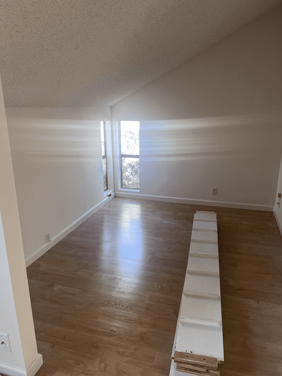 Empty room with newly painted walls and wood flooring