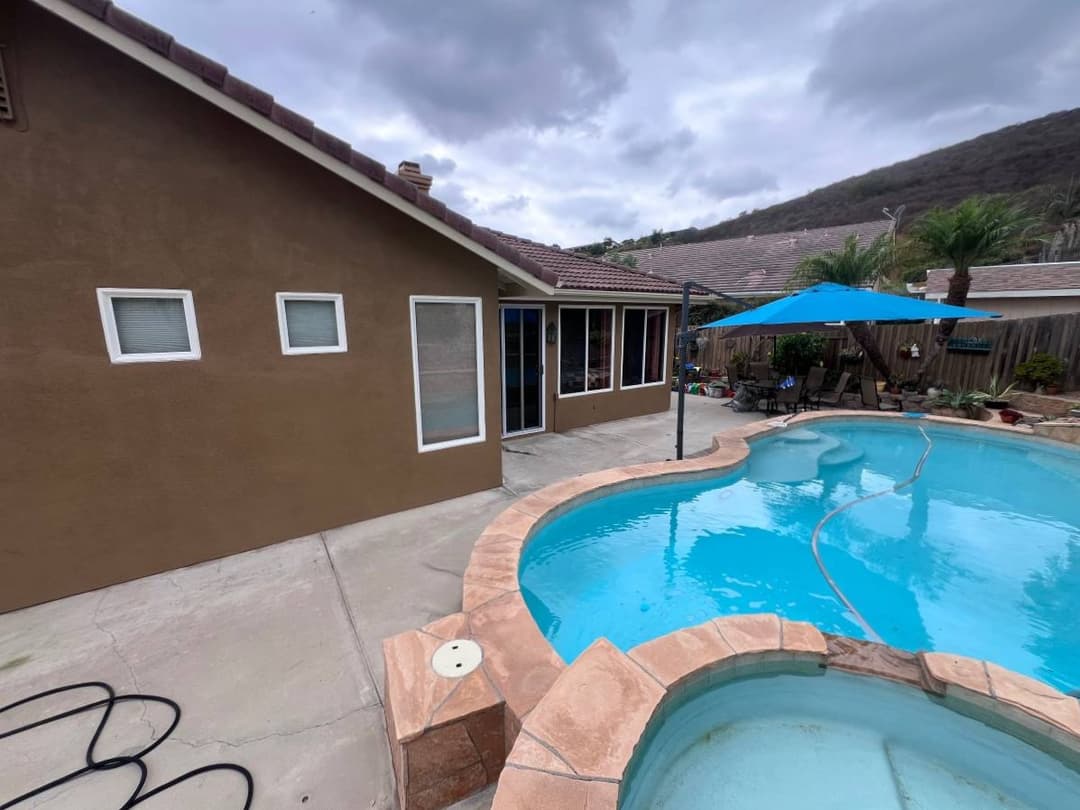 Backyard with swimming pool and freshly painted exterior home