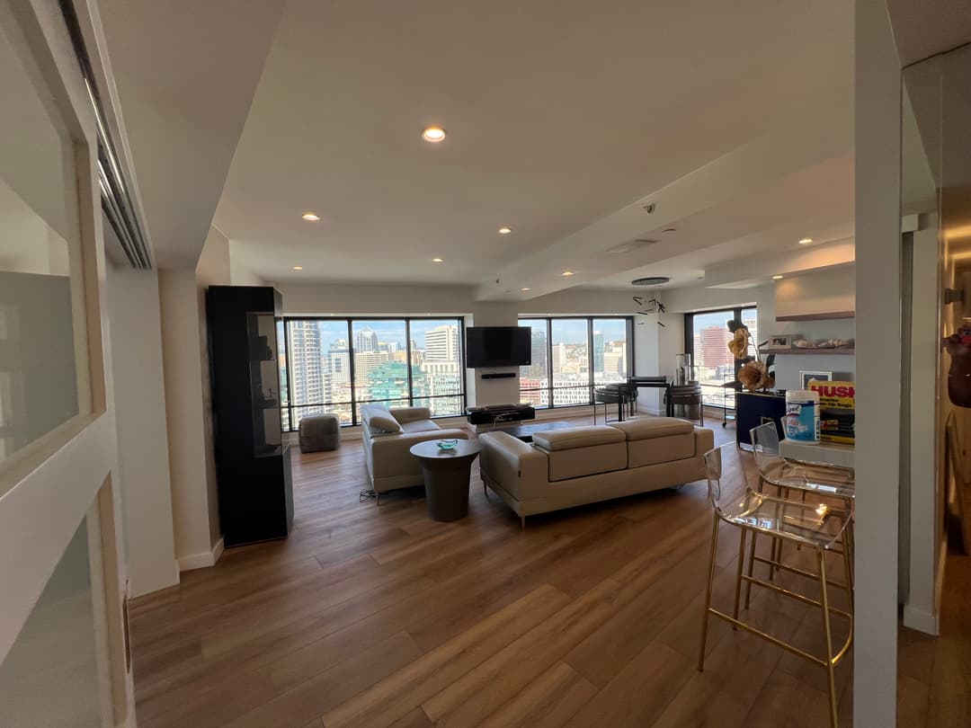 Open-concept living room interior painting with large windows and natural light