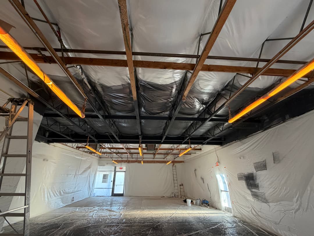 Ceiling drywall installation and insulation during home renovation project